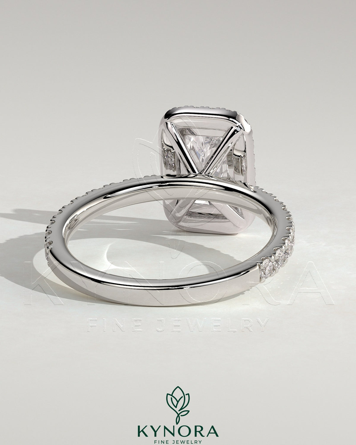 Kynora CJ 2ct radiant cut claw solitaire engagement ring with halo and pave band, showcasing sparkling diamond details.