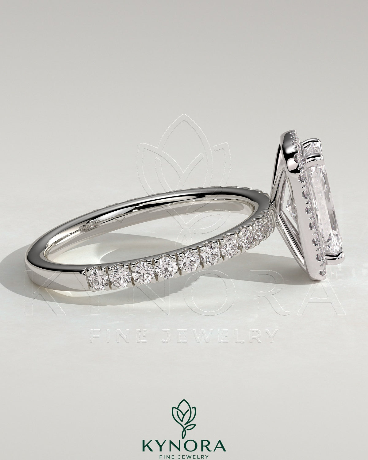 Kynora CJ 2ct radiant claw solitaire engagement ring with halo and pavé band, showcasing sparkling diamond details.