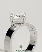 Kynora CJ 2ct Asscher cut diamond solitaire engagement ring with claw setting, offset design, and flat cigar band.