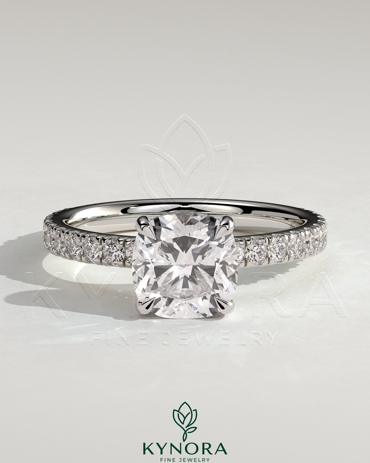 Kynora CJ 2ct cushion claw solitaire engagement ring with hidden halo and pavé band, showcasing elegant diamond design.