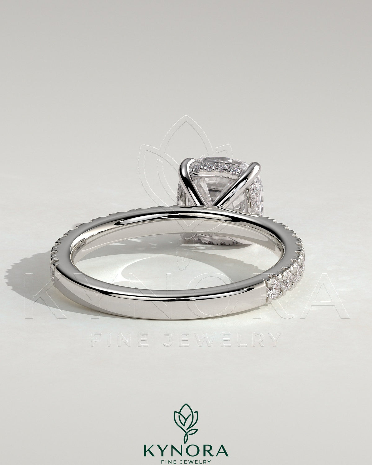 Kynora CJ 2ct cushion claw solitaire engagement ring with hidden halo and pave band, featuring sparkling diamond details.