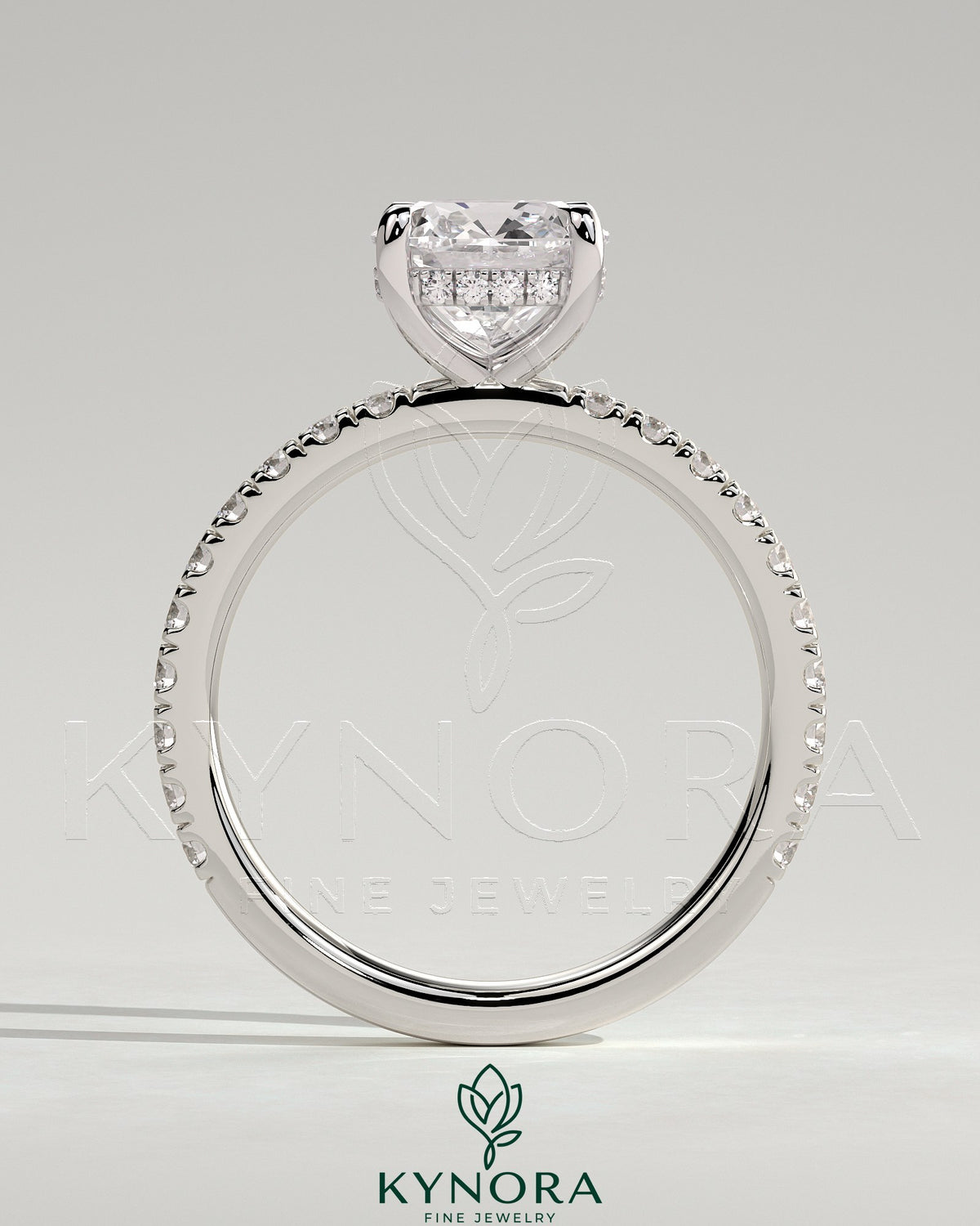 Kynora CJ 2ct cushion cut solitaire engagement ring with hidden halo and pave band in silver setting.