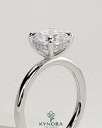 Kynora CJ 2ct cushion claw solitaire engagement ring with hidden halo, featuring a sparkling central diamond and elegant design.