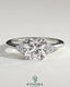 Kynora CJ 2-carat cushion claw solitaire engagement ring with round shoulder stones, featuring a sparkling central diamond and elegant design.