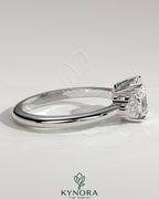 Kynora CJ 2ct cushion claw solitaire engagement ring with round shoulder stones, featuring a sparkling center stone and intricate band design.