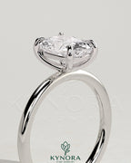 Kynora CJ 2ct elongated cushion cut diamond solitaire engagement ring with a sleek gold band.