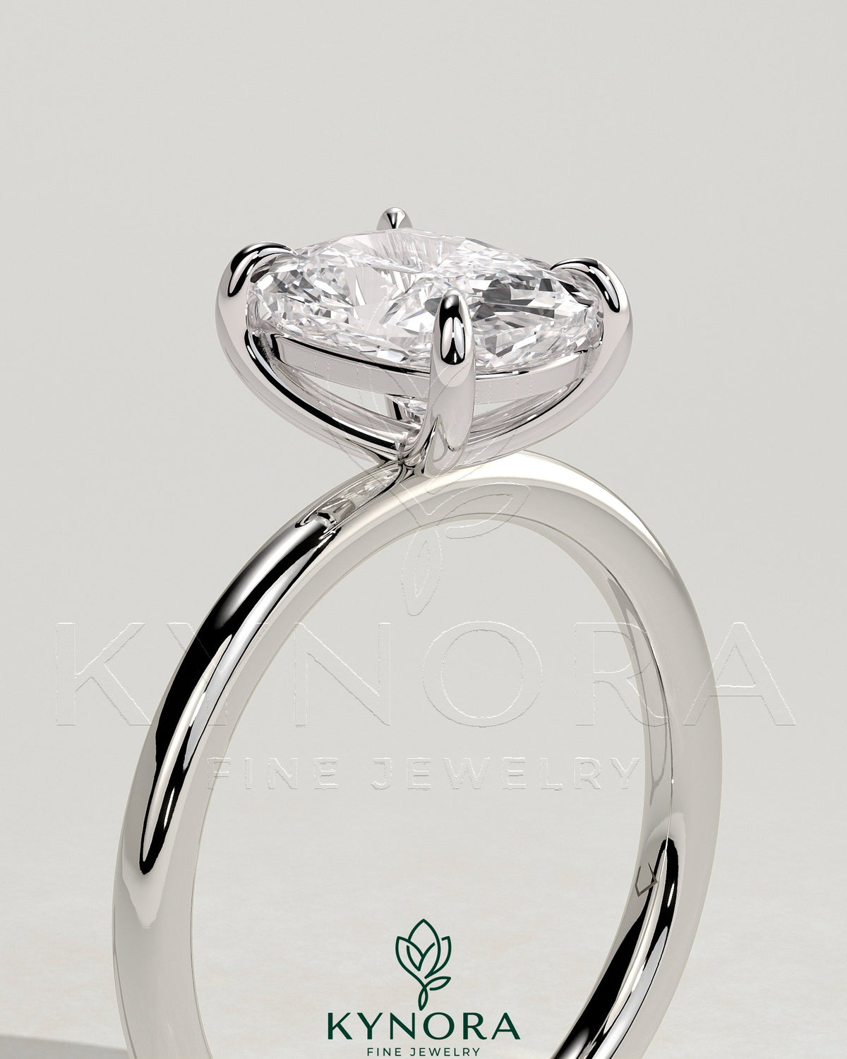 Kynora CJ 2ct elongated cushion cut diamond solitaire engagement ring with a sleek gold band.