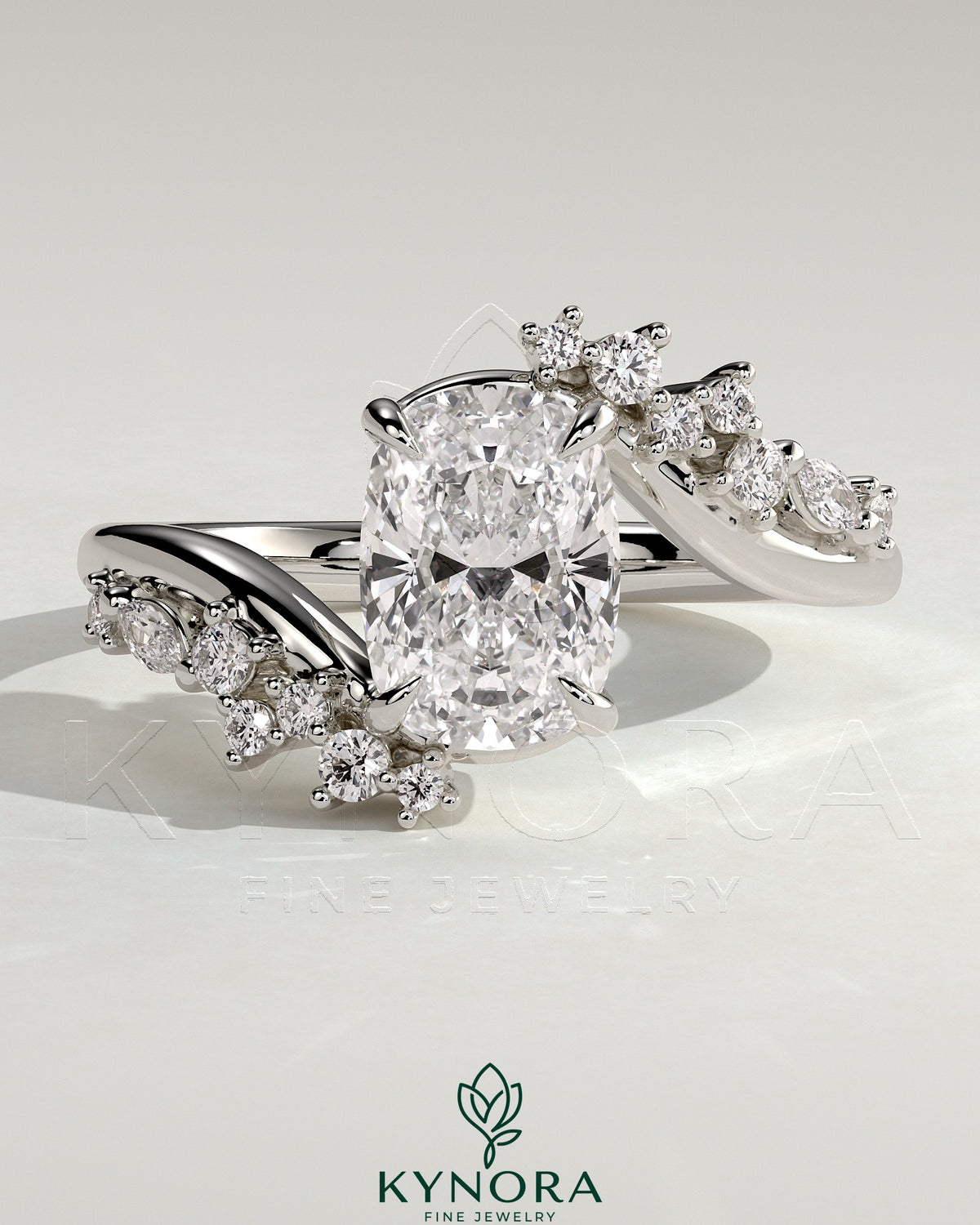 Kynora CJ 2ct elongated cushion claw solitaire engagement ring with bypass band and clustered round-marquise accent stones.