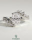 Kynora CJ 2ct elongated cushion claw solitaire engagement ring with bypass band and clustered round-marquise accent stones.