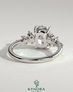 Kynora CJ 2ct elongated cushion claw solitaire engagement ring with cluster round shoulder stones, elegant and sparkling jewelry piece