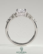 Kynora CJ 2-carat elongated cushion claw solitaire engagement ring with clustered round shoulder stones, silver band.