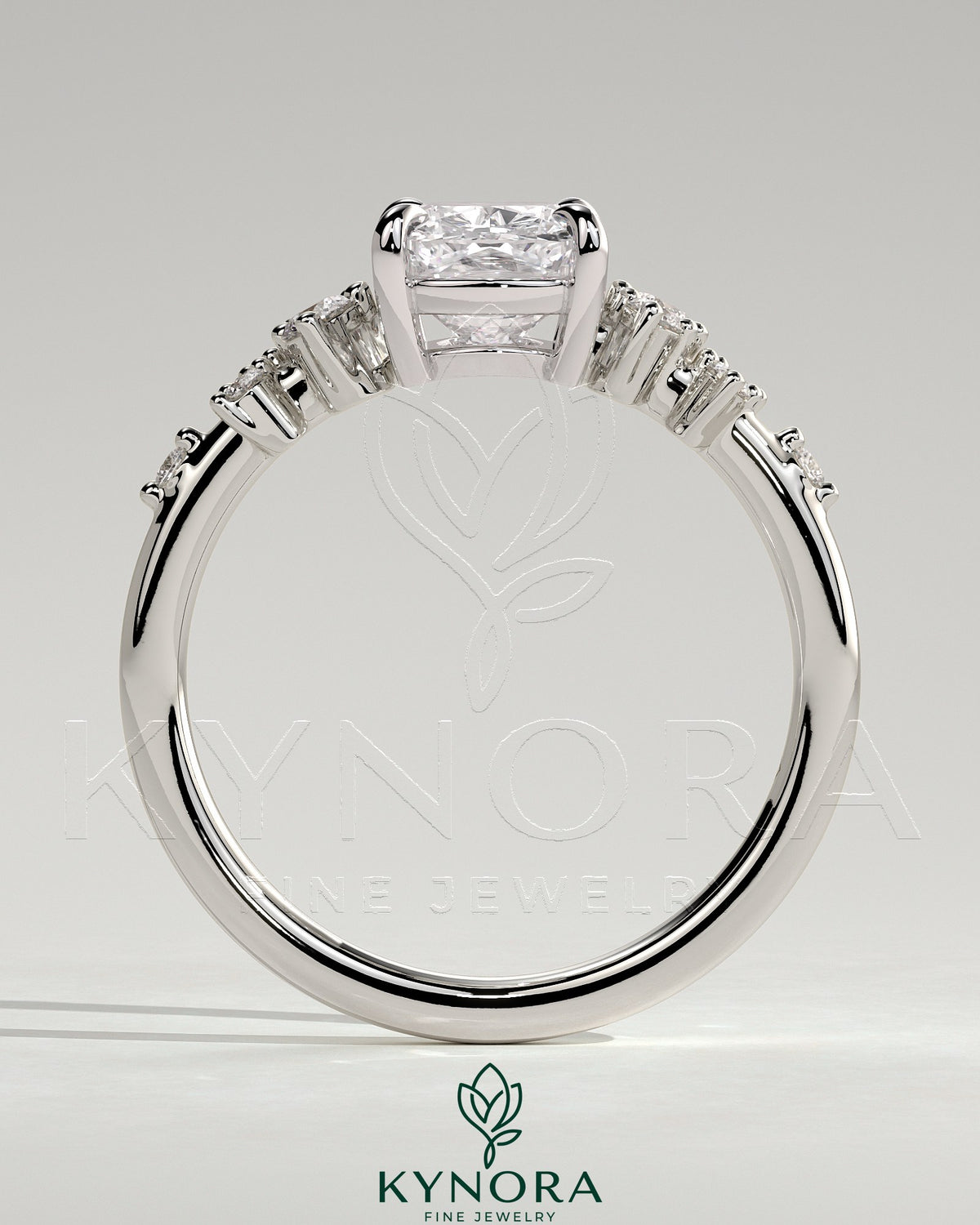 Kynora CJ 2-carat elongated cushion claw solitaire engagement ring with clustered round shoulder stones, silver band.