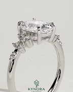 Kynora CJ 2ct elongated cushion claw solitaire engagement ring with clustered round shoulder stones, showcasing elegant jewelry design.