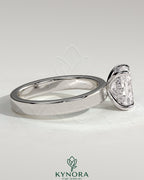 Kynora CJ 2ct elongated cushion cut solitaire engagement ring with flat cigar band and hidden halo design.