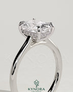 Kynora CJ 2ct elongated cushion diamond solitaire engagement ring with hidden halo and cathedral high setting.