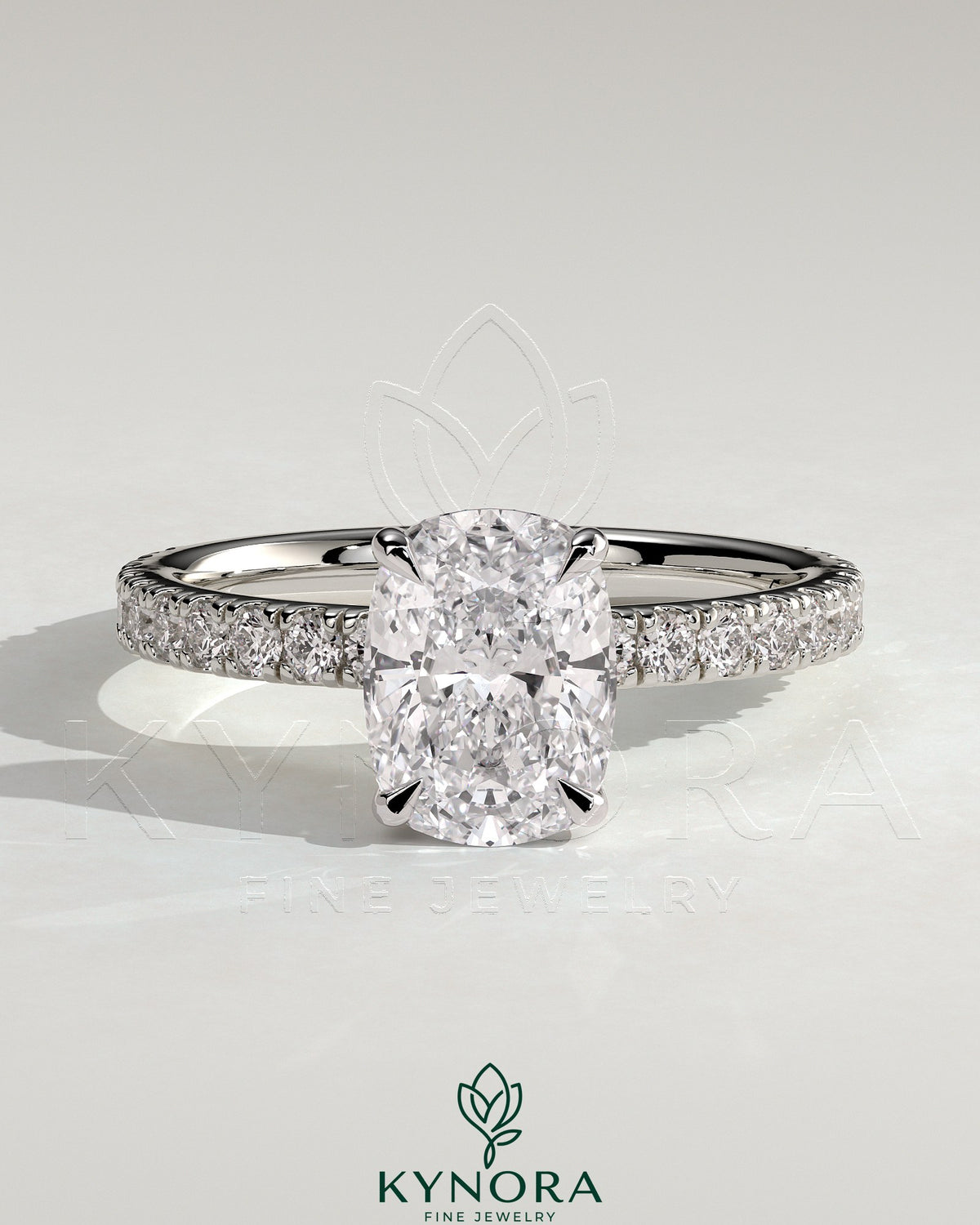 Kynora CJ 2-carat elongated cushion claw solitaire engagement ring with hidden halo and pave band, showcasing sparkling diamond details. Main image