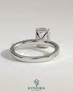 Kynora CJ 2ct elongated cushion solitaire engagement ring with hidden halo and pave band, featuring a sparkling diamond centerpiece.