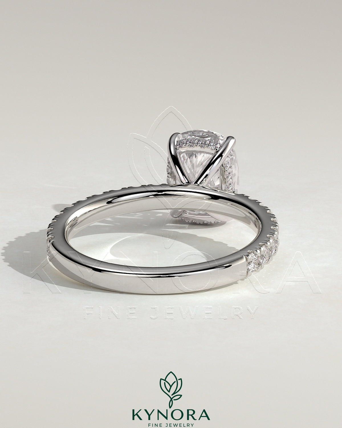 Kynora CJ 2ct elongated cushion solitaire engagement ring with hidden halo and pave band, featuring a sparkling diamond centerpiece.