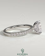 Kynora CJ 2ct elongated cushion claw solitaire engagement ring with hidden halo and pave band, showcasing fine diamond craftsmanship.