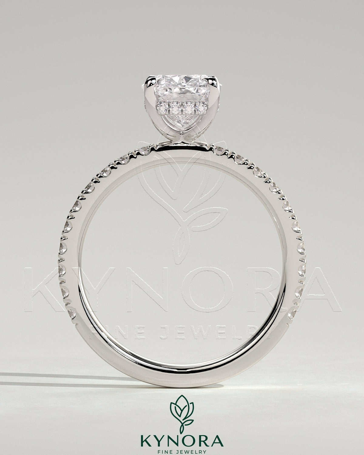 Kynora CJ 2ct elongated cushion solitaire engagement ring with hidden halo and pave band in white gold.