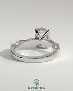 Kynora CJ 2ct elongated cushion solitaire engagement ring with hidden halo and twisted pave band, showcasing intricate design and brilliance.
