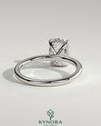 Kynora CJ 2ct elongated cushion cut solitaire engagement ring with hidden halo and prong setting, featuring sparkling diamond accents.