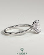 Kynora CJ 2ct elongated cushion cut solitaire engagement ring with hidden halo, featuring a sleek gold band and sparkling center stone.