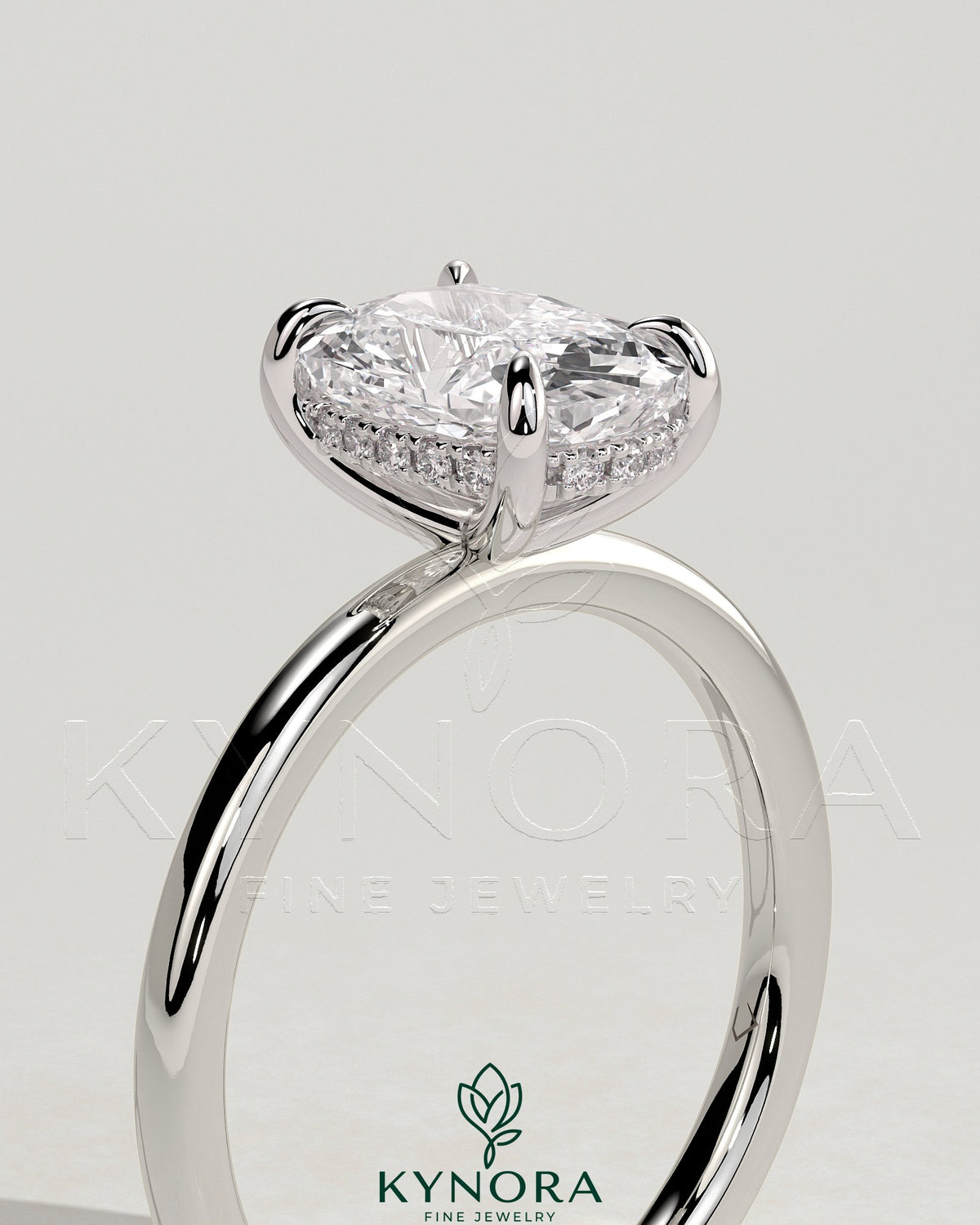 Kynora CJ 2ct elongated cushion diamond solitaire engagement ring with hidden halo, featuring a sleek gold band on a white background.