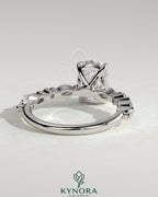 Kynora CJ 2ct elongated cushion solitaire engagement ring with marquise and round accent stones, elegant jewelry piece.