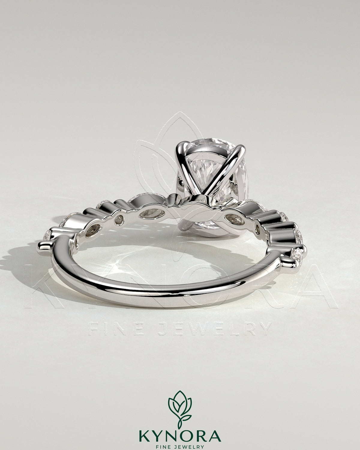 Kynora CJ 2ct elongated cushion solitaire engagement ring with marquise and round accent stones, elegant jewelry piece.