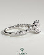 Kynora CJ 2ct elongated cushion claw solitaire engagement ring with marquise and round accent stones.