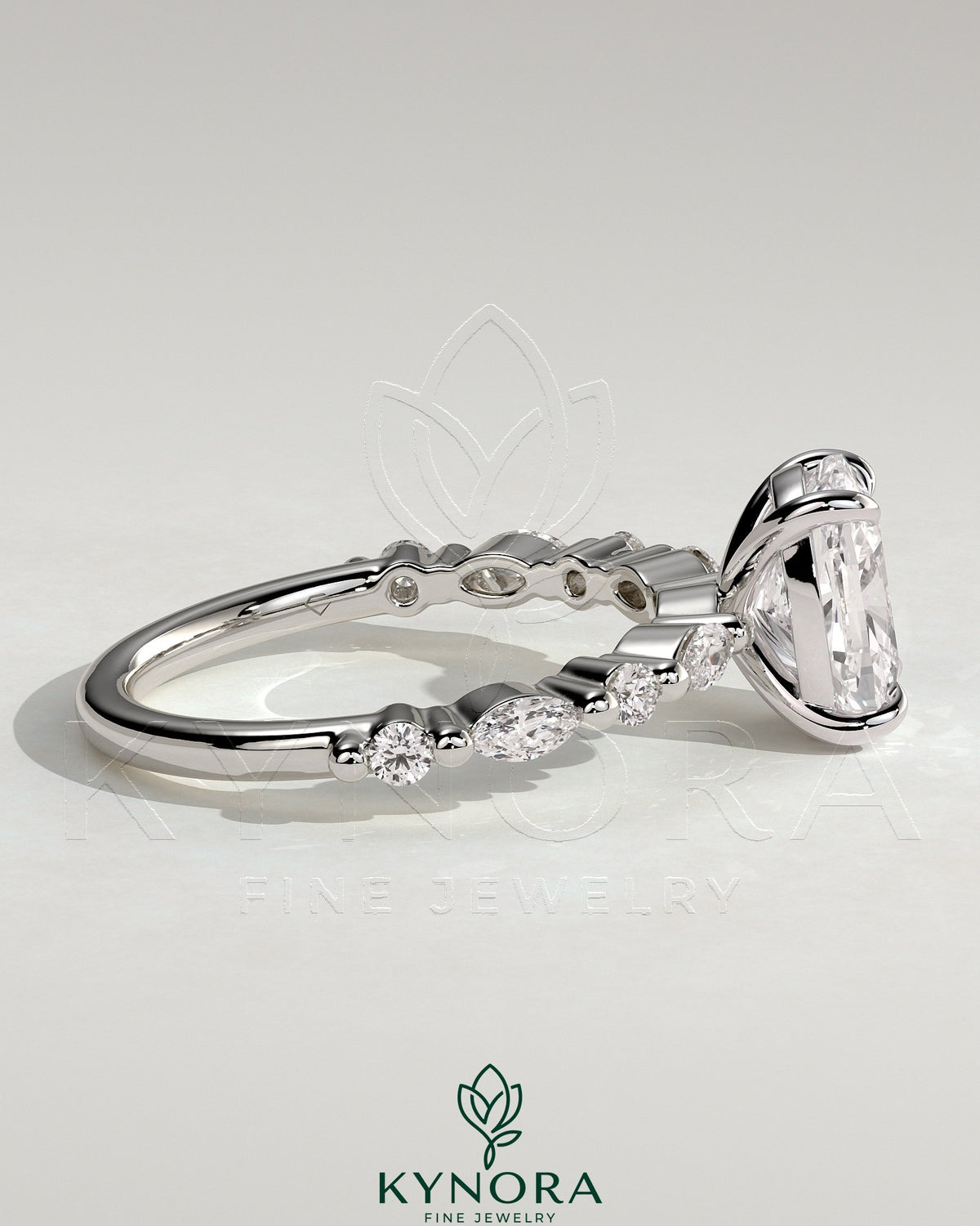 Kynora CJ 2ct elongated cushion claw solitaire engagement ring with marquise and round accent stones.
