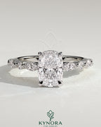 Kynora CJ 2ct elongated cushion solitaire engagement ring with marquise, round accent stones, and hidden halo design.