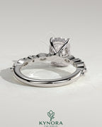 Kynora CJ 2ct elongated cushion claw solitaire engagement ring with marquise and round accent stones and hidden halo.