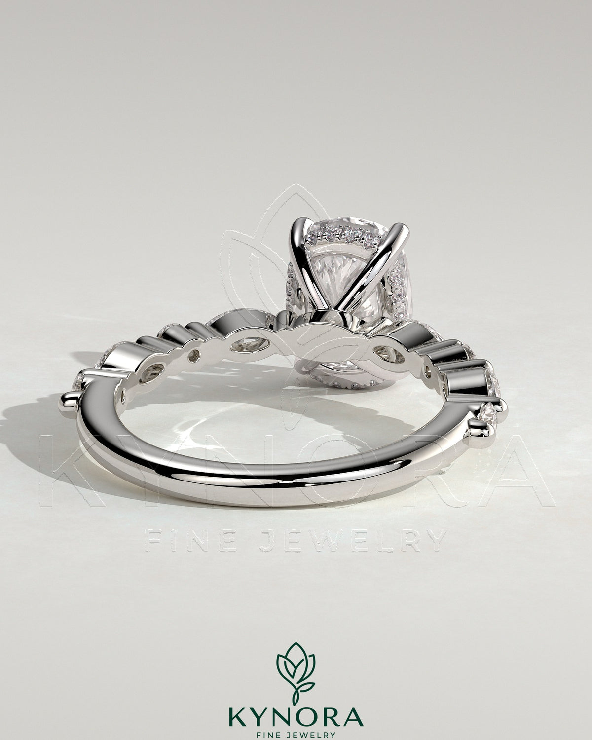 Kynora CJ 2ct elongated cushion claw solitaire engagement ring with marquise and round accent stones and hidden halo.