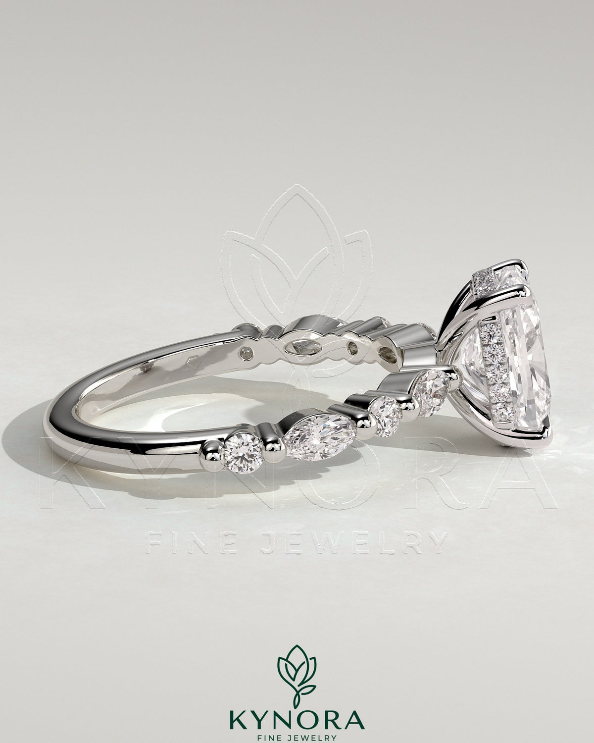 Kynora CJ 2ct elongated cushion solitaire engagement ring with marquise and round accent stones, hidden halo design.