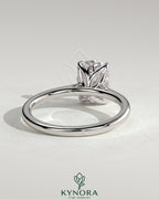 Kynora CJ 2ct elongated cushion claw solitaire engagement ring with petal gallery, leaf accents, and cathedral setting.