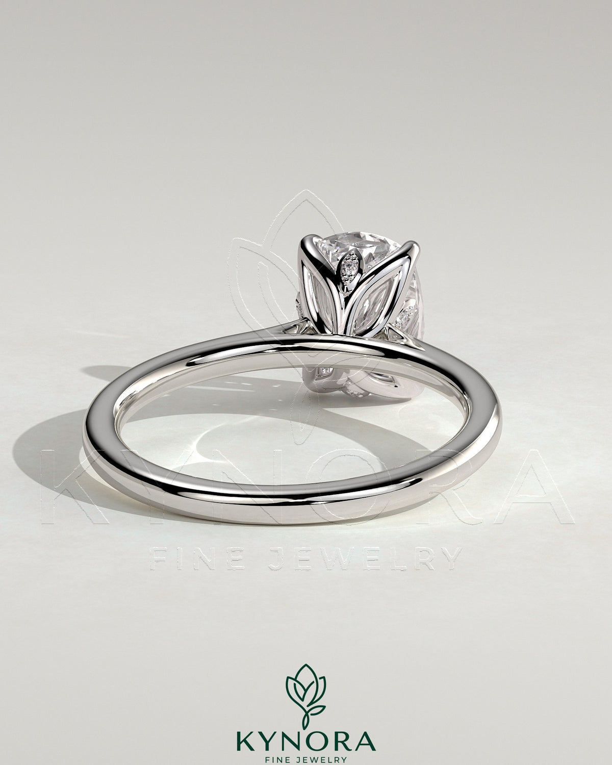 Kynora CJ 2ct elongated cushion claw solitaire engagement ring with petal gallery, leaf accents, and cathedral setting.