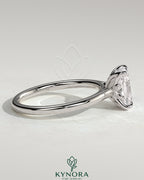 Kynora CJ 2ct elongated cushion solitaire engagement ring with petal gallery, leaf accents, and cathedral setting.