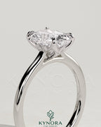 Kynora CJ 2ct elongated cushion cut diamond solitaire engagement ring with petal gallery, leaf accents, and cathedral setting.