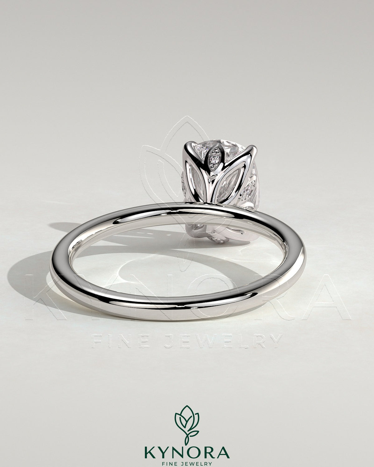 Kynora CJ 2ct elongated cushion solitaire engagement ring with petal gallery and leaf accents, featuring a sparkling central diamond.