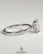 Kynora CJ 2ct elongated cushion claw solitaire engagement ring with petal gallery and leaf accents in gold.