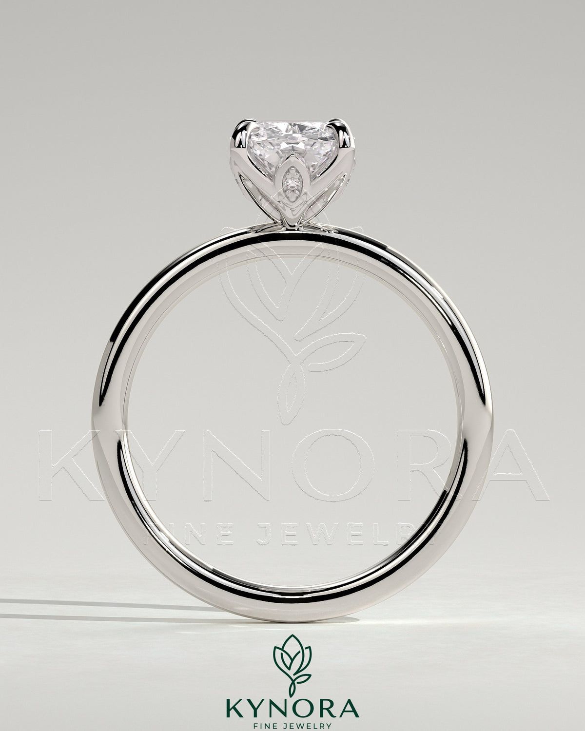 Kynora CJ 2ct elongated cushion claw solitaire engagement ring with petal gallery and accent leaf details, gold band.