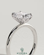 Kynora CJ 2ct elongated cushion claw solitaire engagement ring with petal gallery and leaf accents in gold.