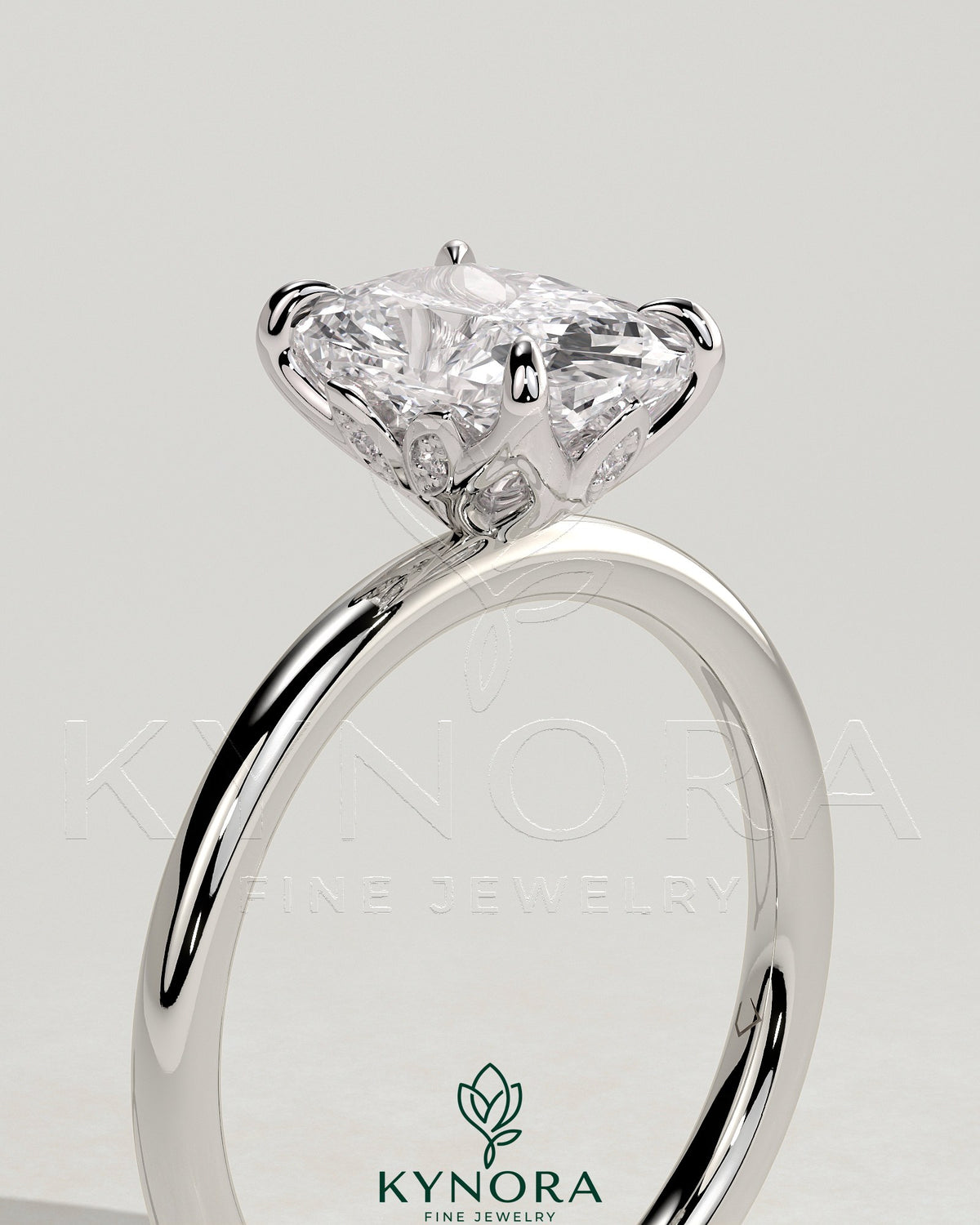 Kynora CJ 2ct elongated cushion claw solitaire engagement ring with petal gallery and leaf accents in gold.