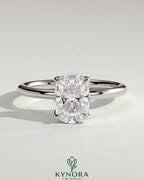 Kynora CJ 2ct elongated cushion claw solitaire engagement ring with petal gallery and accented tiara detail, featuring a sparkling diamond.