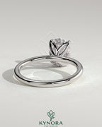 Kynora CJ 2ct elongated cushion claw solitaire engagement ring with petal gallery and accented tiara detail on a ring display