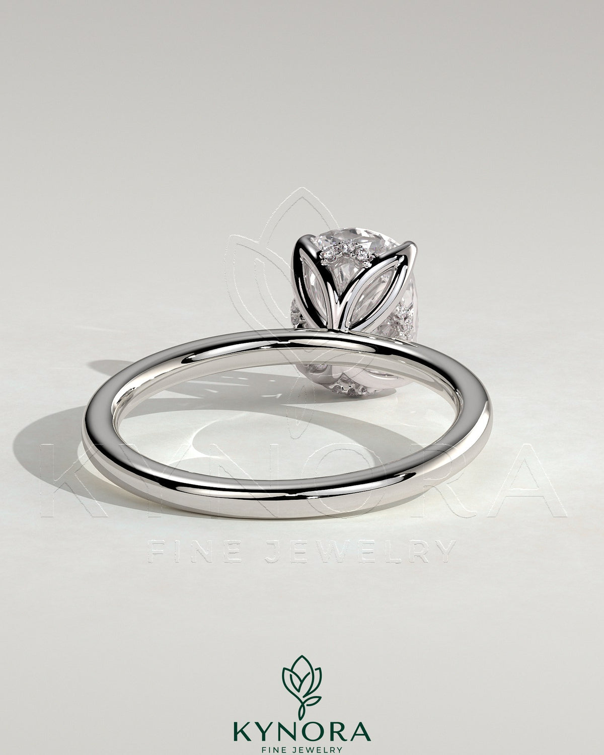Kynora CJ 2ct elongated cushion claw solitaire engagement ring with petal gallery and accented tiara detail on a ring display