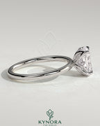 Kynora CJ 2ct elongated cushion cut solitaire engagement ring with petal gallery and accented tiara detail, showcasing intricate design.