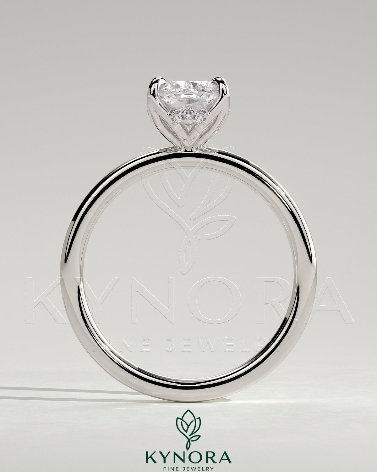 Kynora CJ 2ct elongated cushion claw solitaire engagement ring with petal gallery and accented tiara detail.